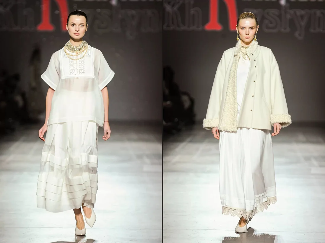 Two white women's looks with embroidery on a runway